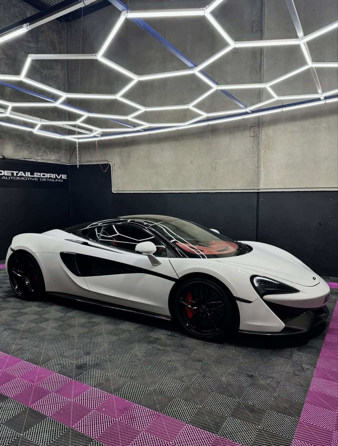 White McLaren 570S detailed and parked side on in the Pakenham studio