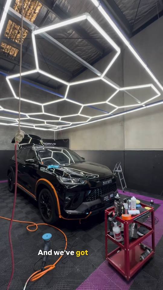 Jesse setting up a coating job under the hexagon light rig at the Pakenham studio